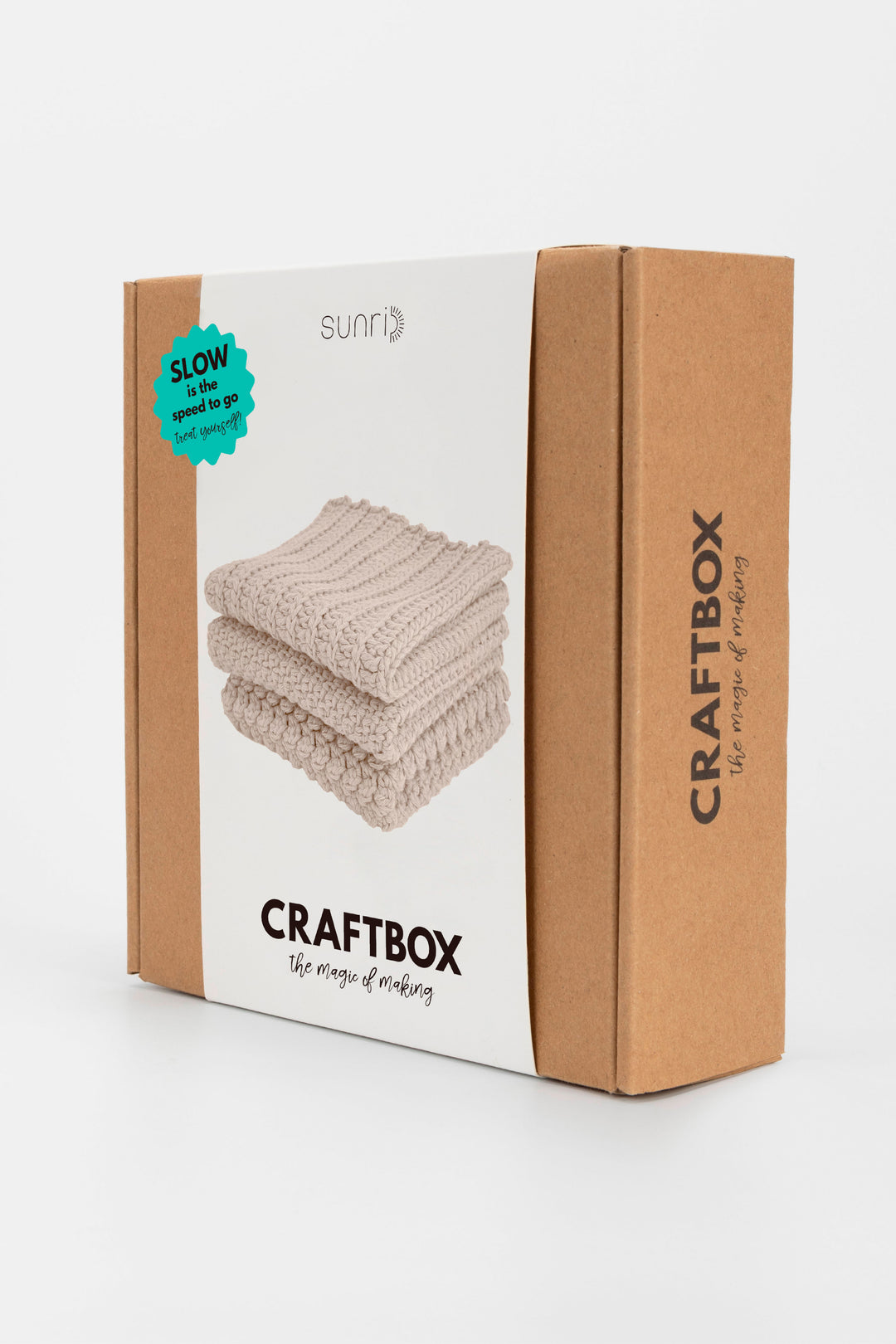 Craftbox packaging with folded fabric on a white background