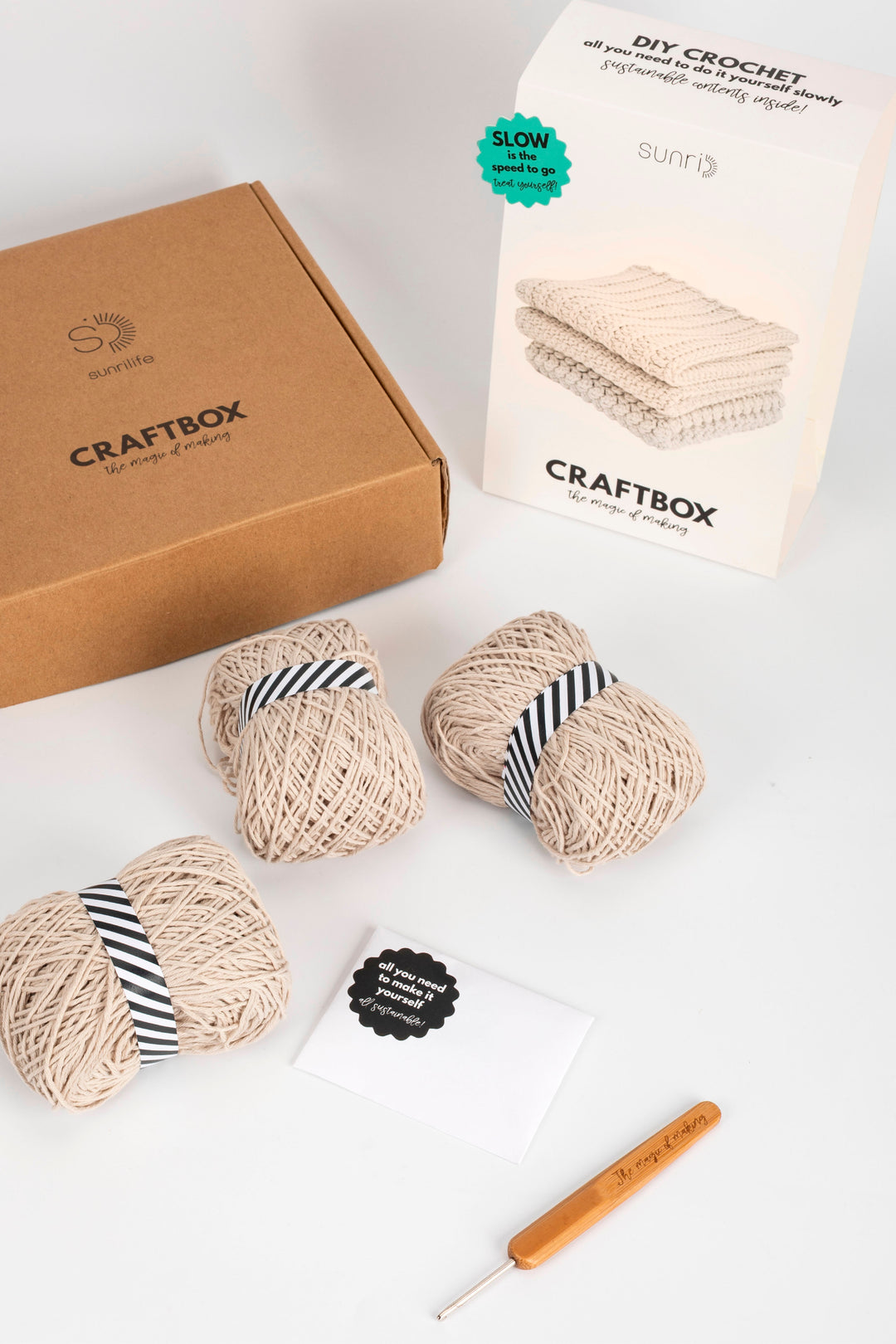 Craftbox DIY crochet kit with yarn, hook, and packaging on a white background