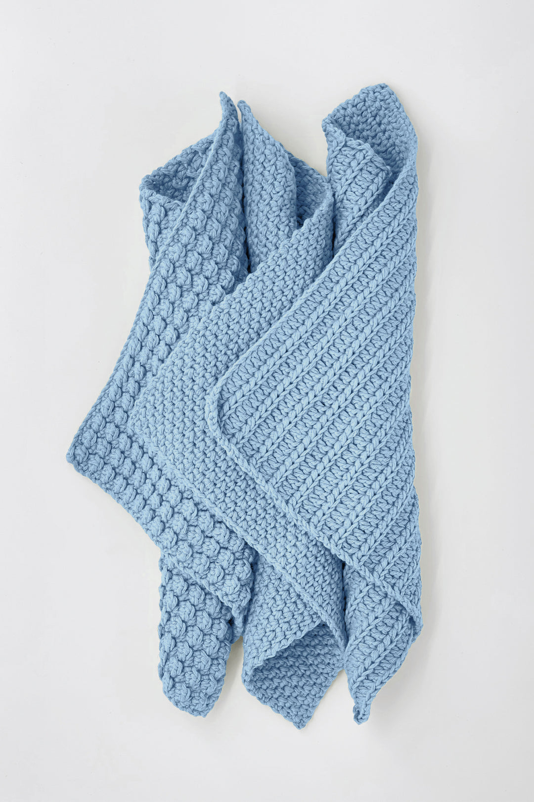 Blue knitted towel on a white background