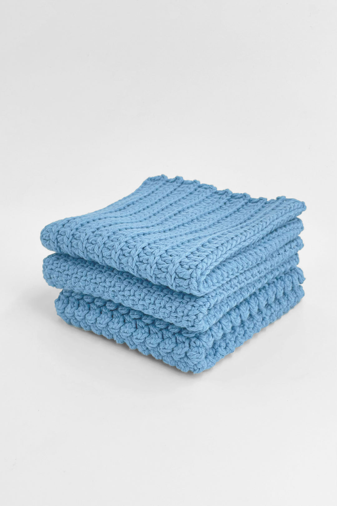 Stack of blue textured towels on a white background
