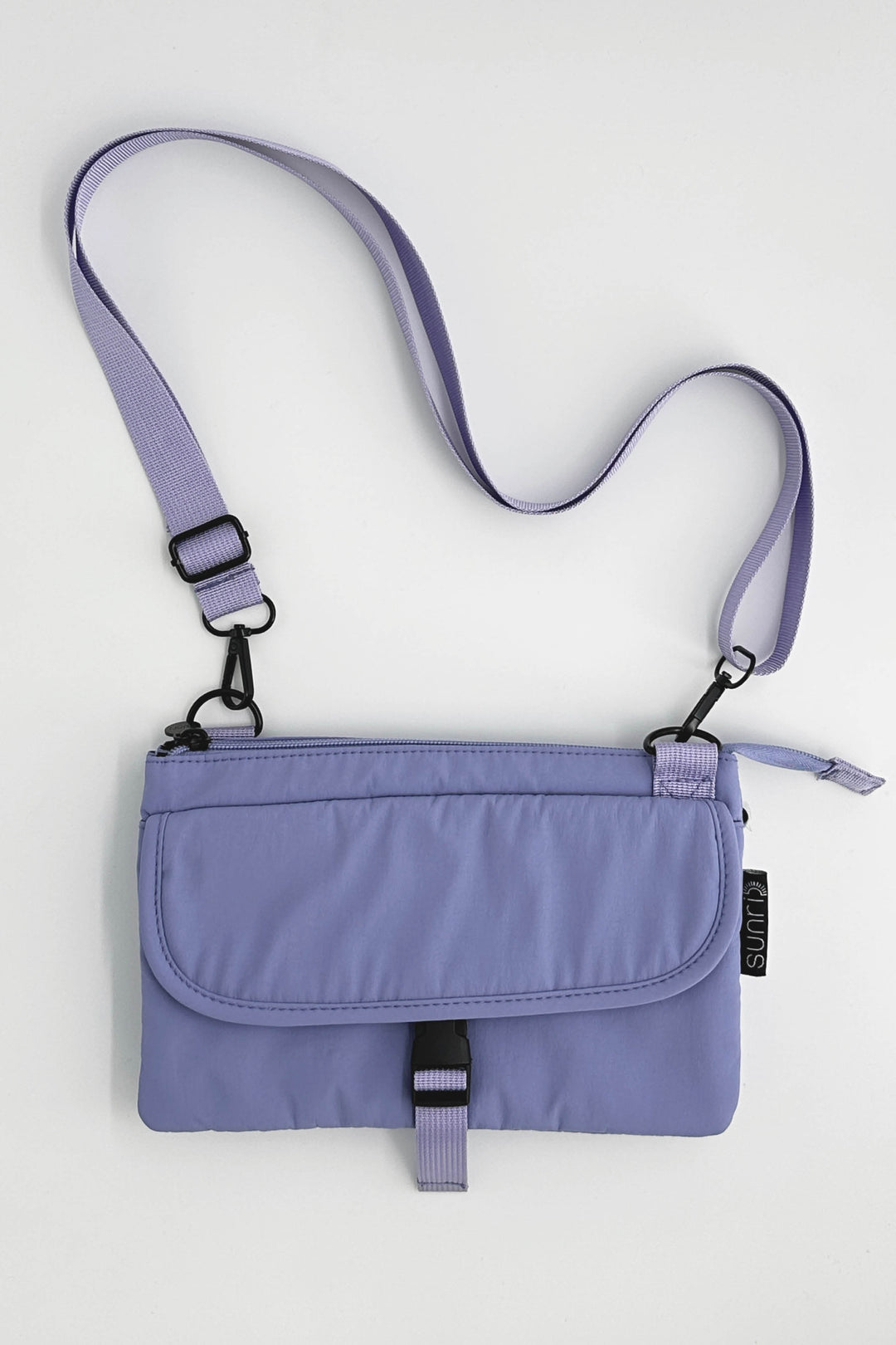 Purple crossbody bag with a strap on a white background