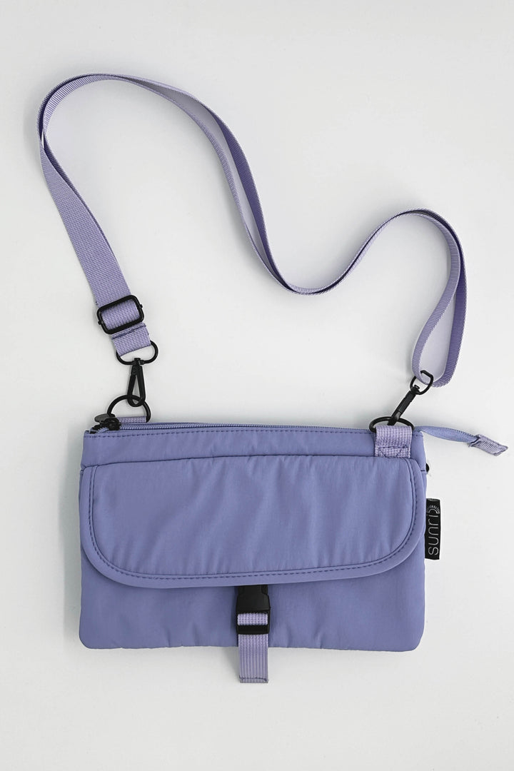 Purple crossbody bag with a strap on a white background