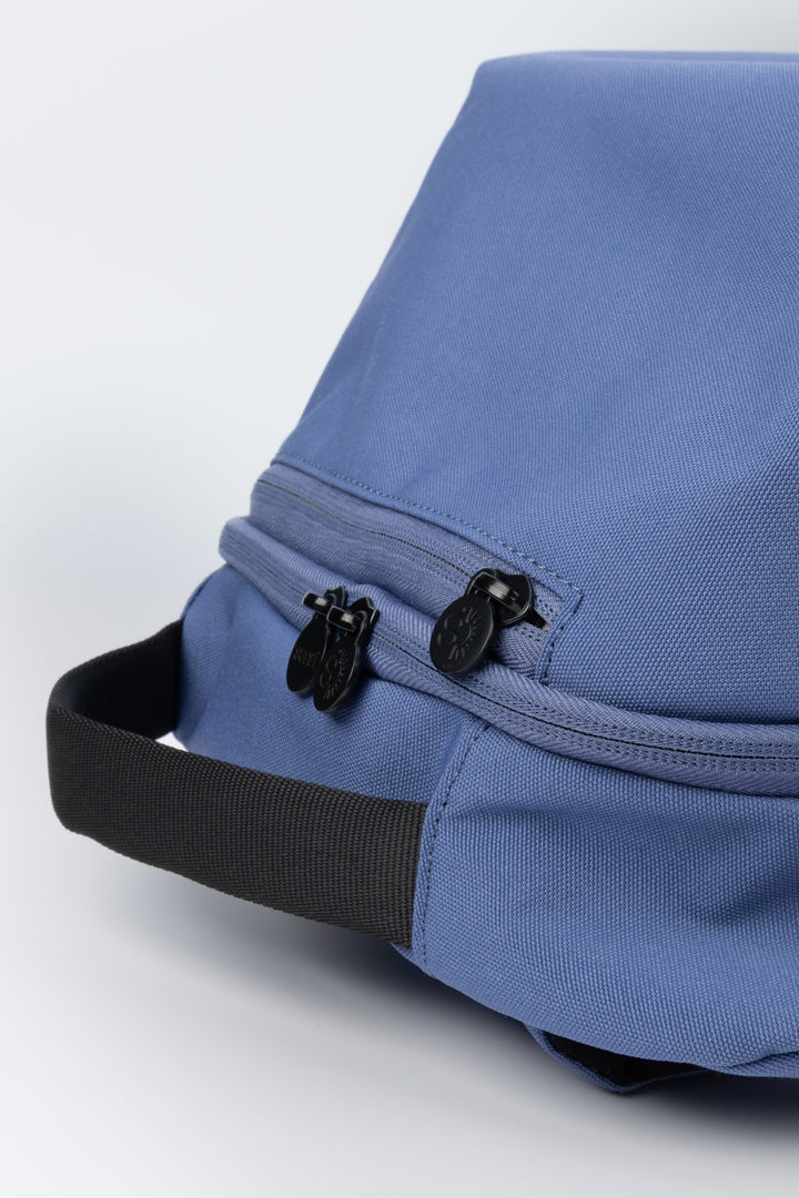 close up of blue laptop backpack top handle and zipper pulls