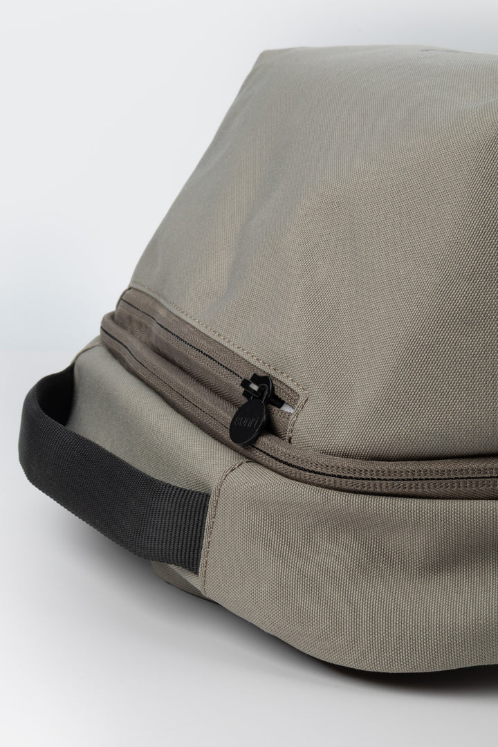close up of grey laptop backpack top handle and zipper pulls
