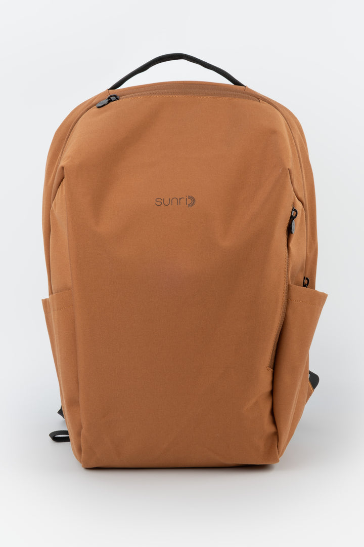 orange laptop backpack front view with subtle sunri logo
