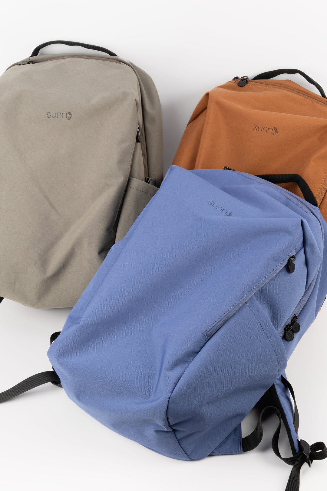 blue laptop backpack next to grey and orange colour options
