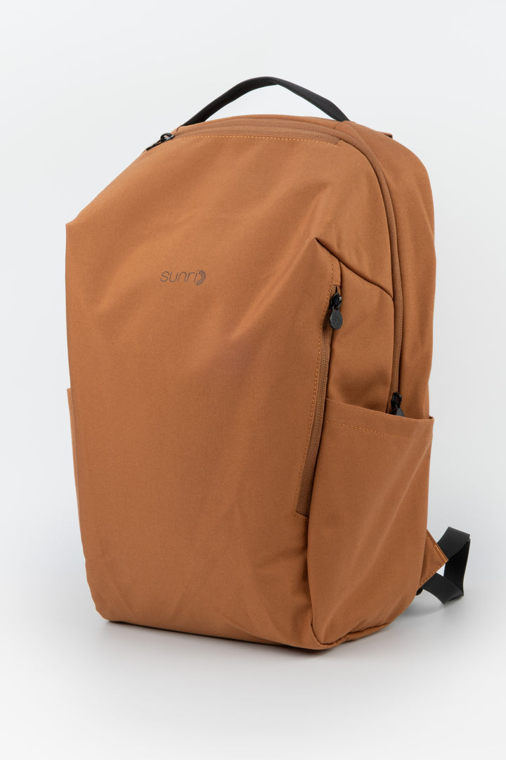 orange laptop backpack three quarter front view with side pockets and sunri zipper pulls
