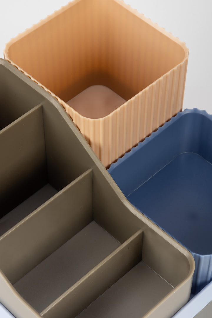 Set of three desk containers in beige, brown, and blue on a white background