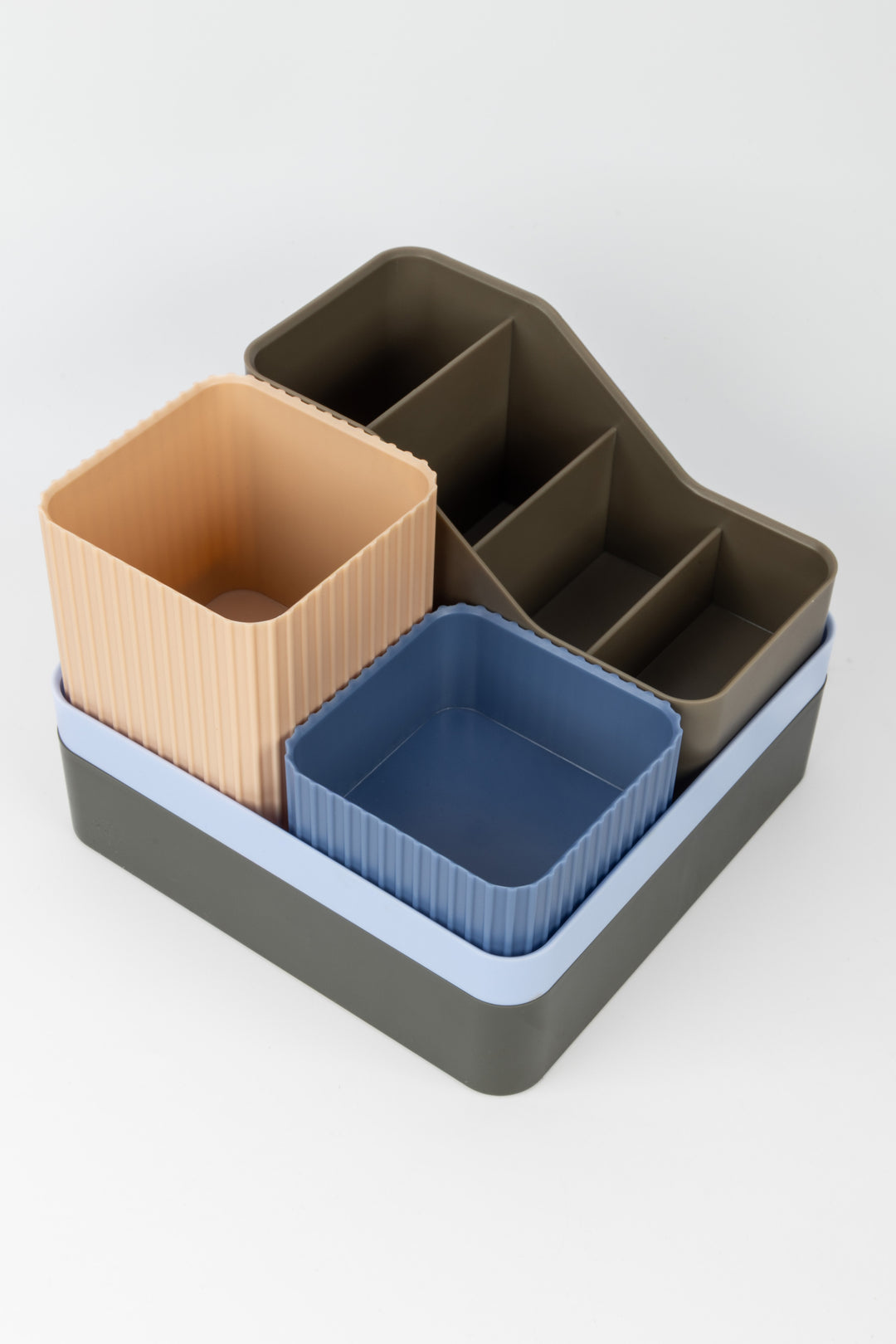 Set of three rectangular containers in brown, blue, and gray on a white background