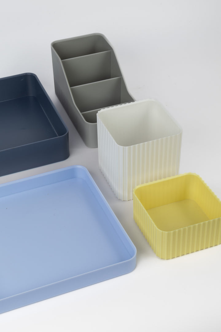 Set of colourful desk organisers on a light gray background