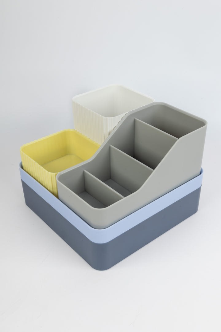 Set of colourful desk organisers on a light gray background