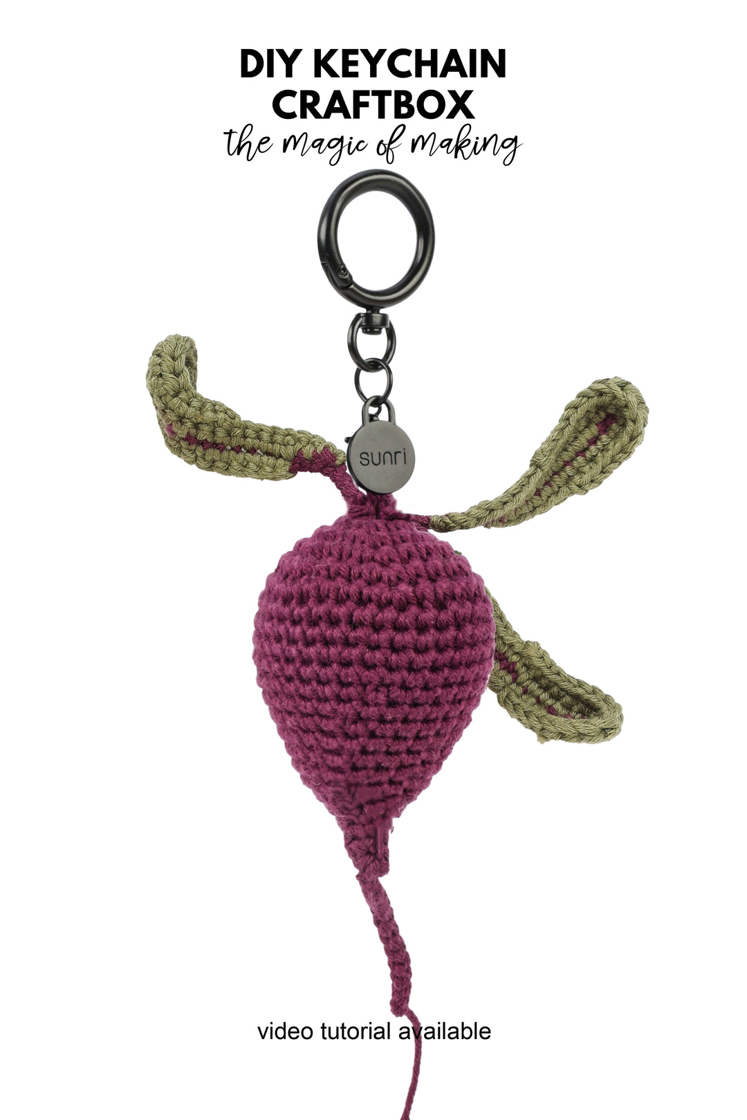 A crocheted keychain featuring a purple beetroplet-shaped charm with olive green leaves and a black metal key ring, shown on a white background with text reading &