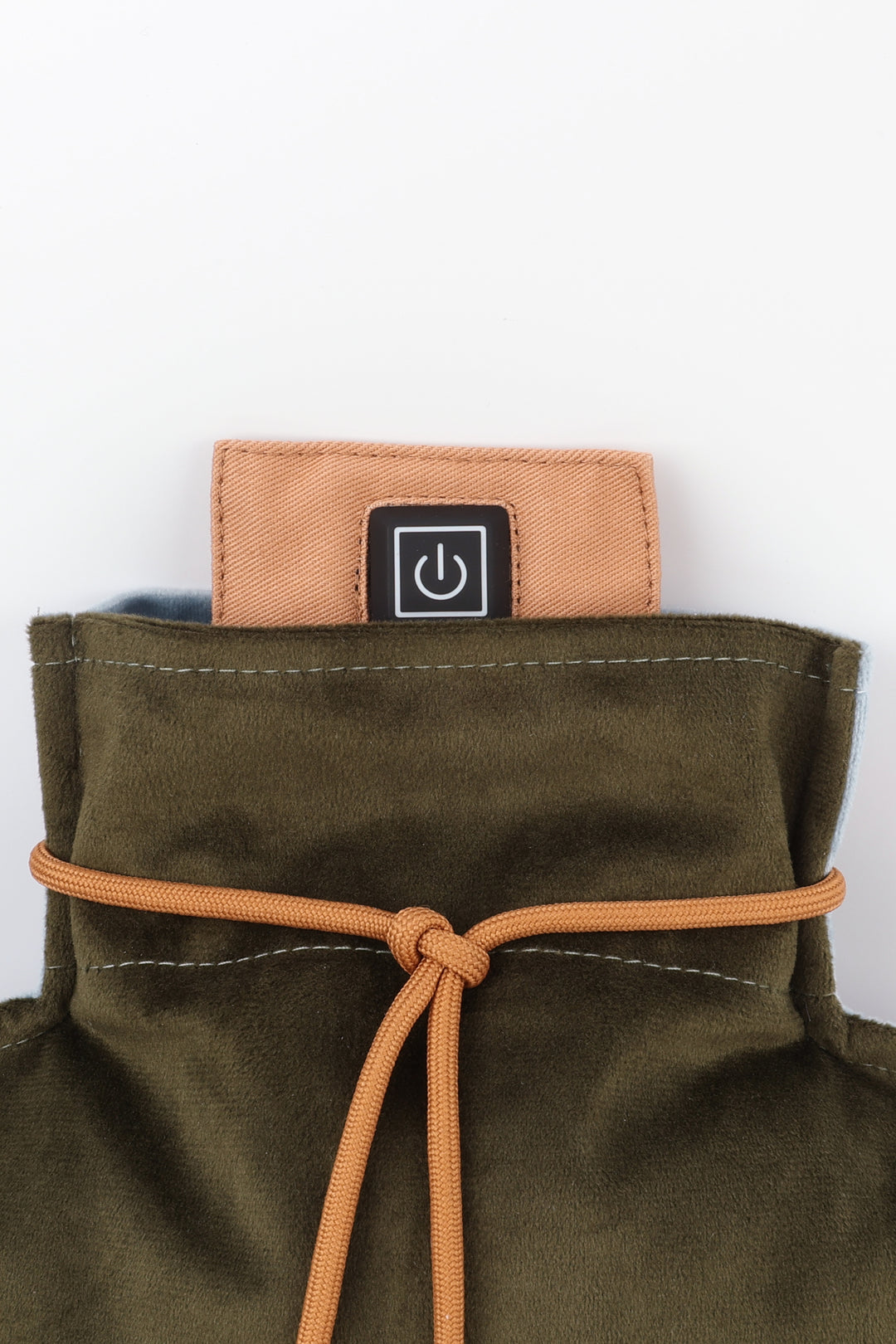 Close-up of a green bag with an orange strap and a power symbol label on a white background