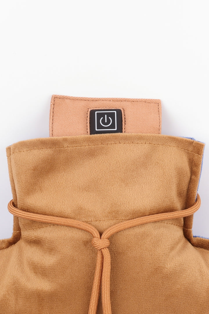 Close-up of a brown velvet pillow cover with a power symbol label on a white background