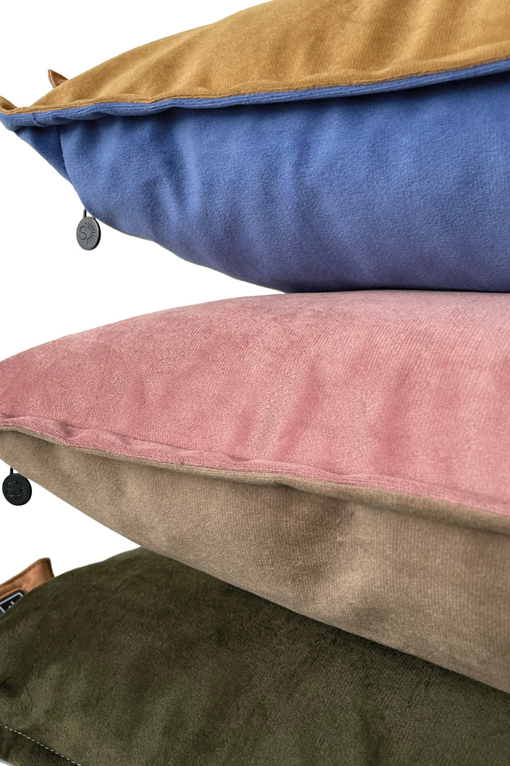 stack of duotone pillows with velvet covers
