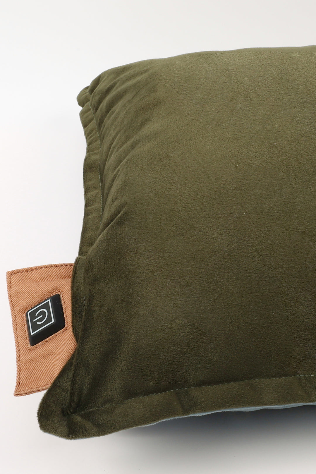 Green pillow with a brown patch on a white background