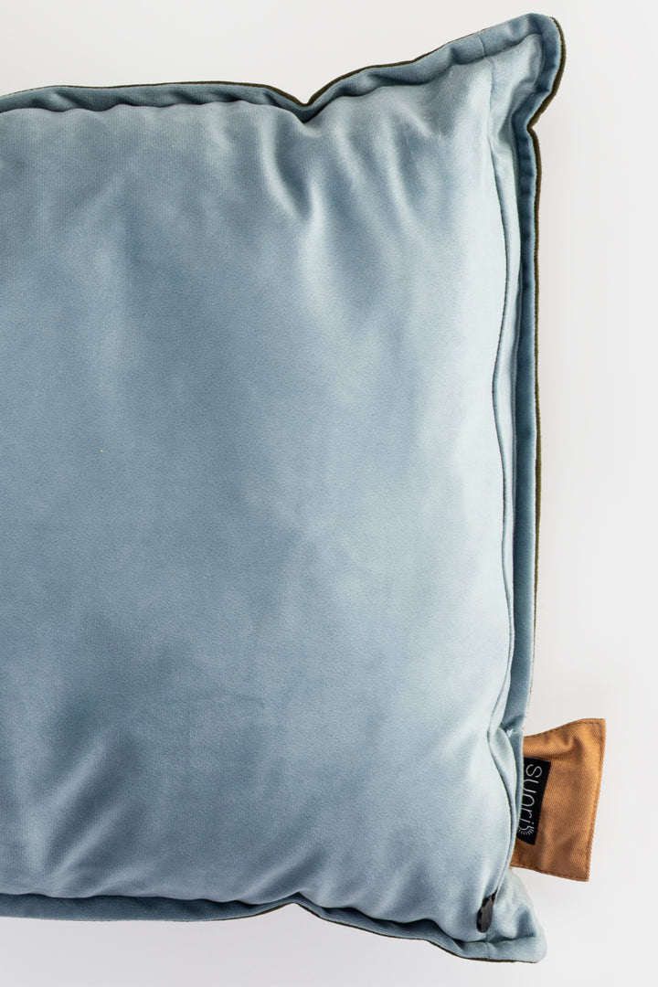 Blue pillow with a brown label on a white background
