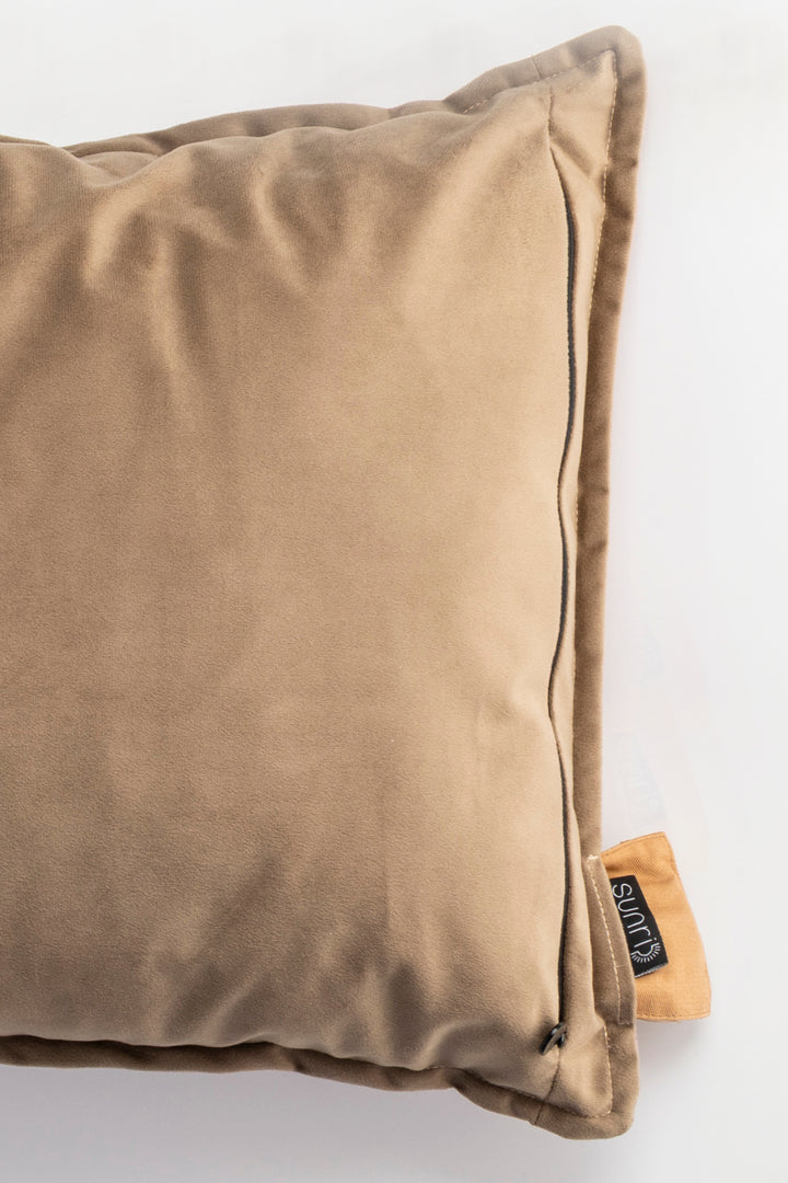 Brown pillow with a brand tag on a white background