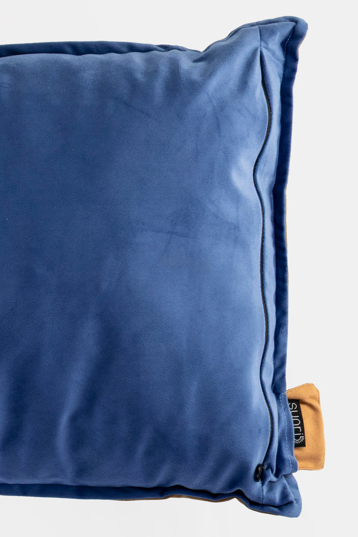 Blue pillow with a brand label on a white background