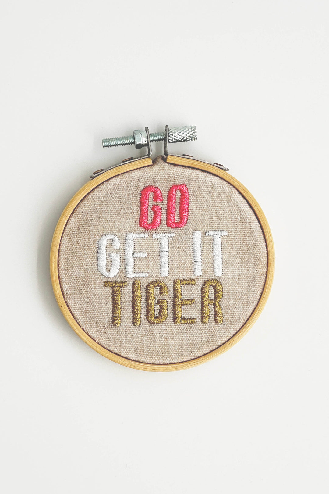 Embroidery hoop with 'GO GET IT TIGER' text on a white background