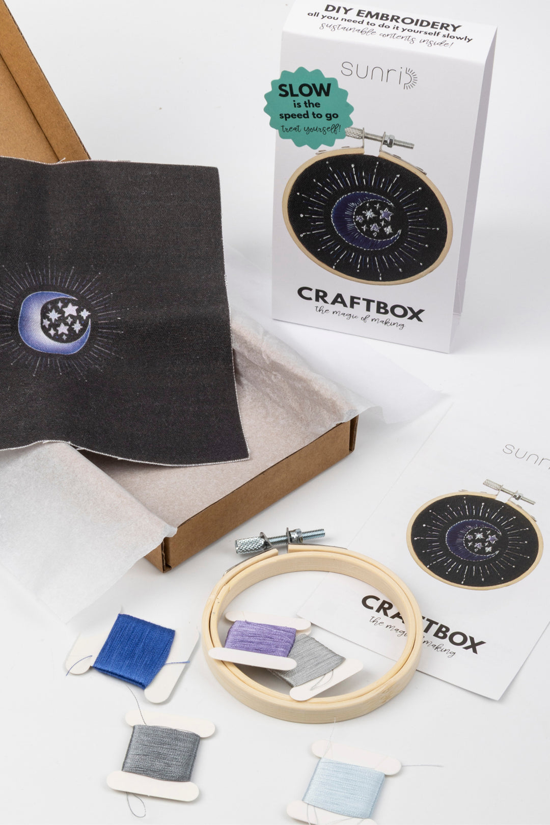 Sunri Craftbox DIY embroidery kit with packaging box, wooden embroidery hoop, embroidery threads, instruction cards and moon design fabric on a white background