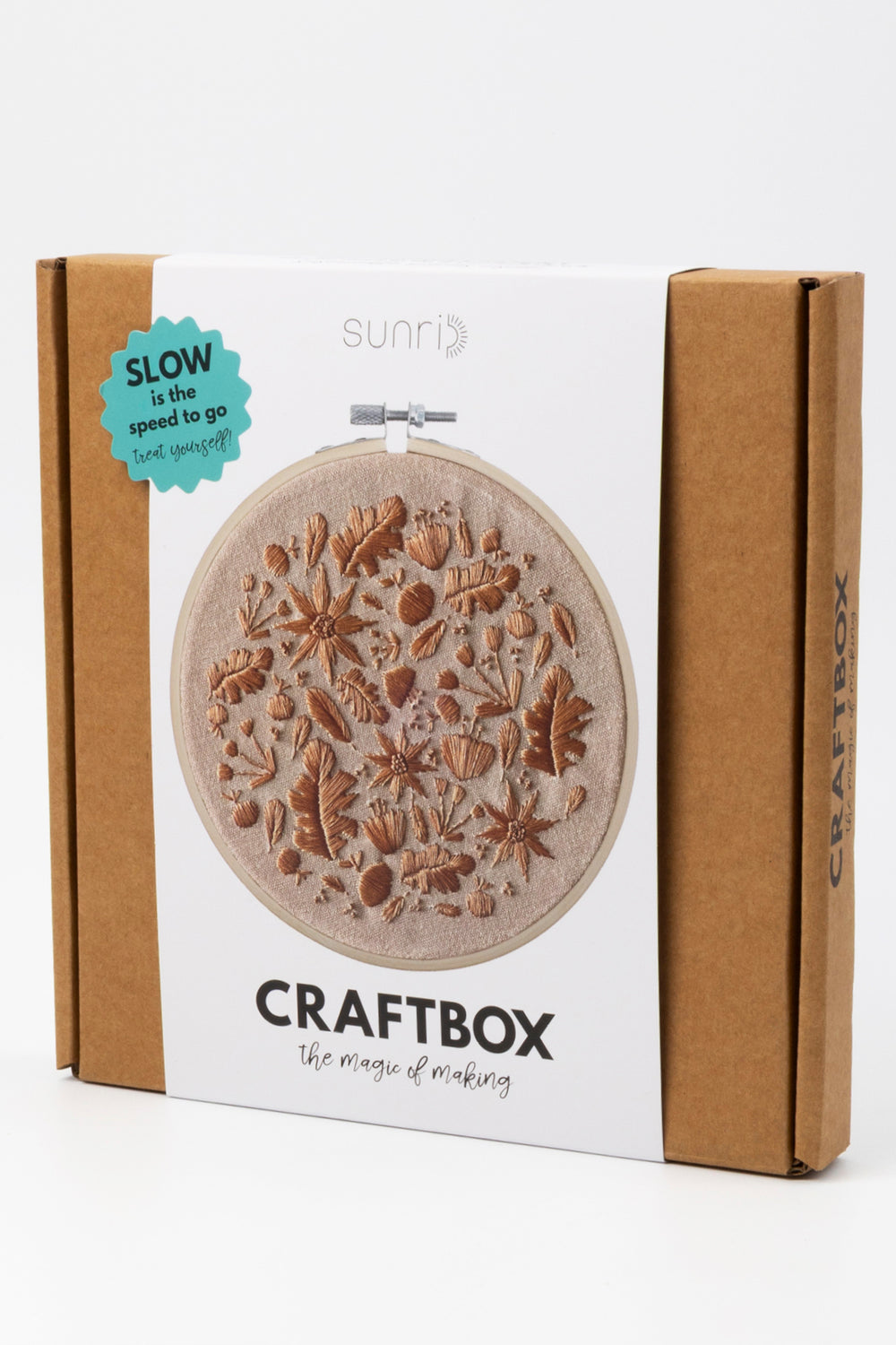Craft box with embroidery hoop and floral design on a white background