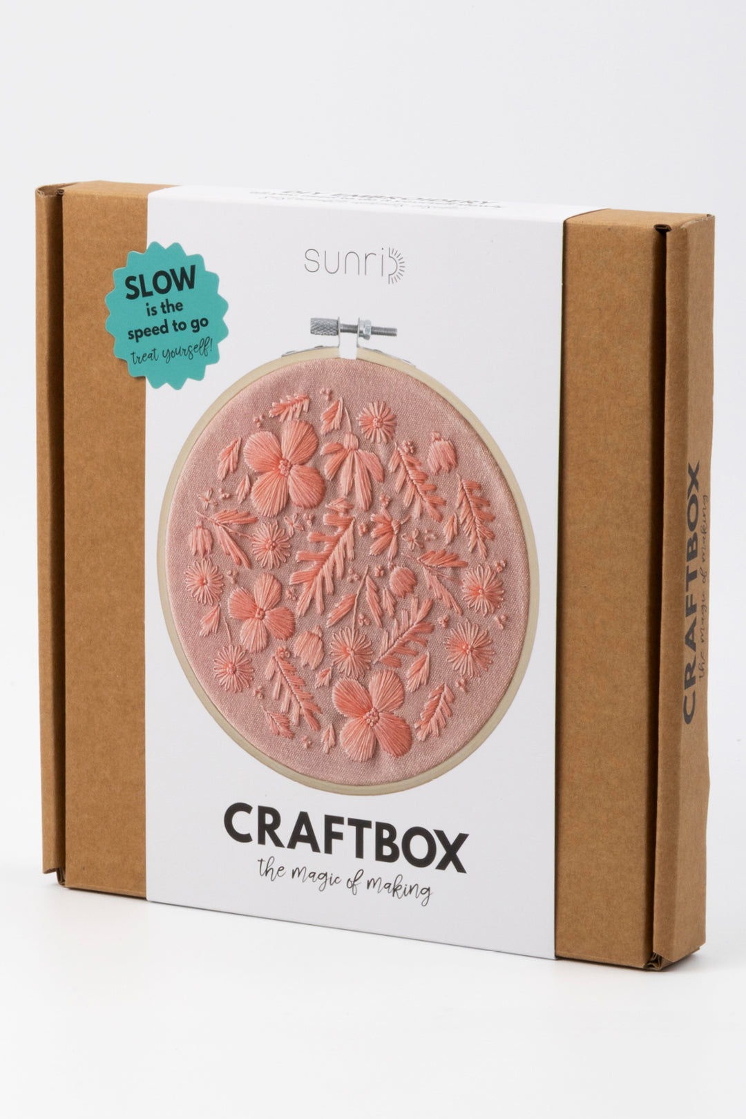 Craft box packaging with embroidery hoop design on a white background
