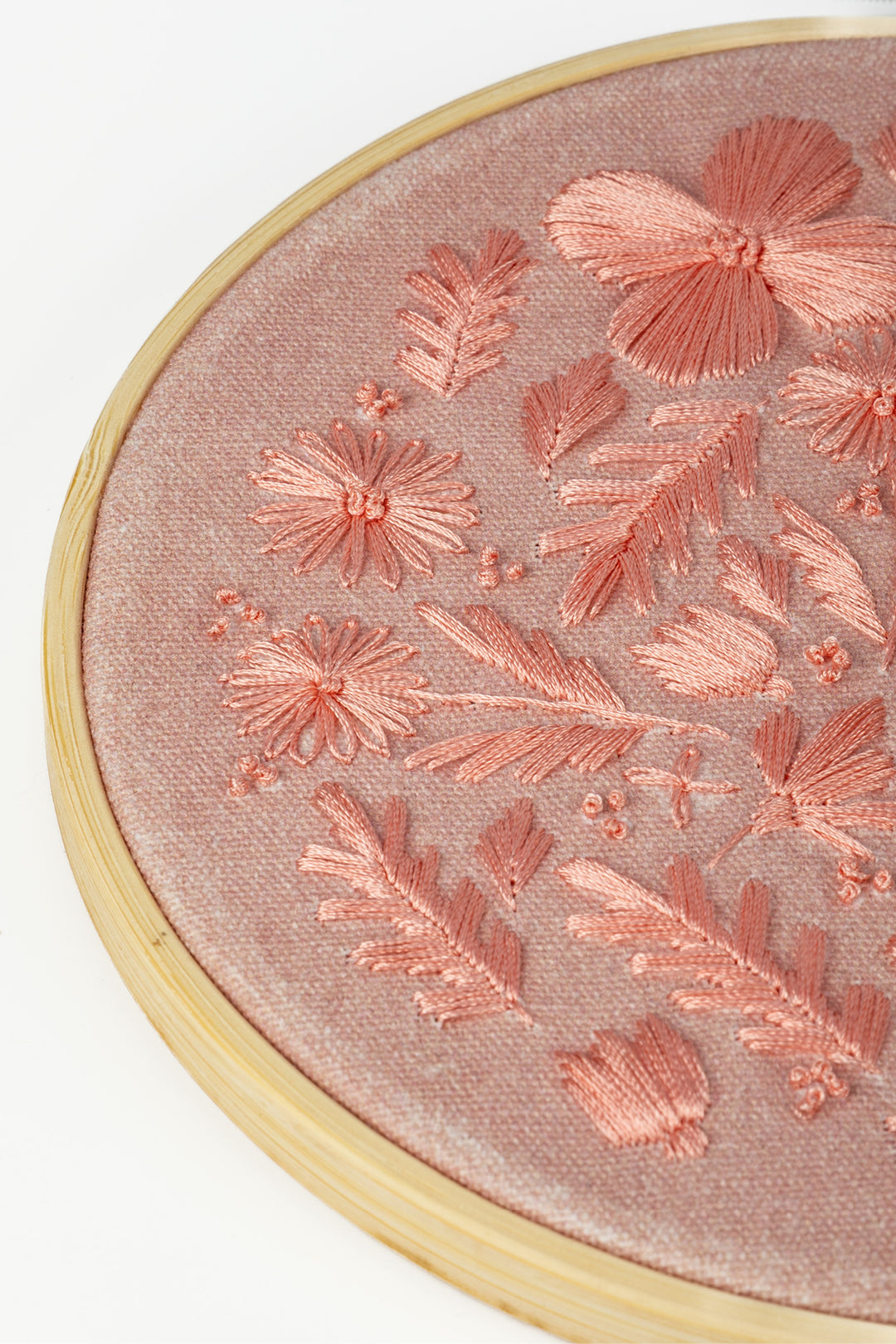 Sunri Craftbox embroidery hoop close up with pink floral stitching on pink fabric