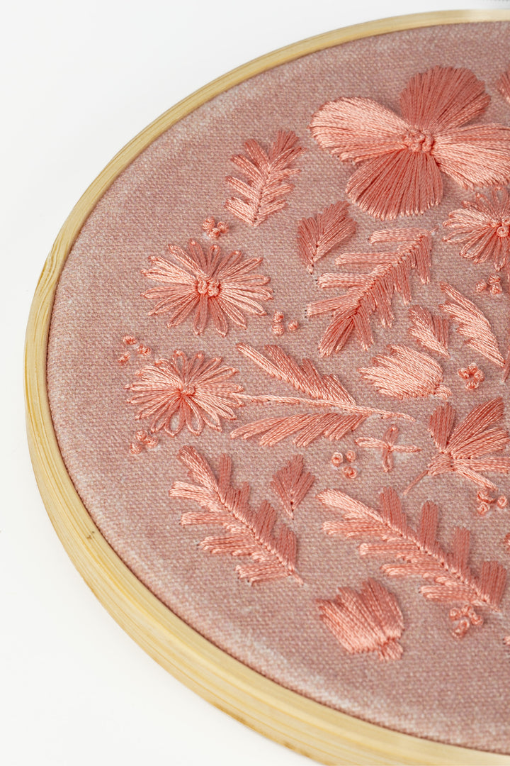 Sunri Craftbox embroidery hoop close up with pink floral stitching on pink fabric