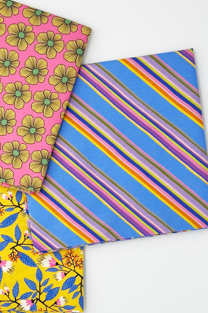 stacked furoshiki wrapping cloths with blue stripe yellow floral and pink floral designs
