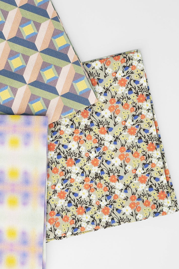 layered furoshiki cloth combining flower print with geometric sensory patterns