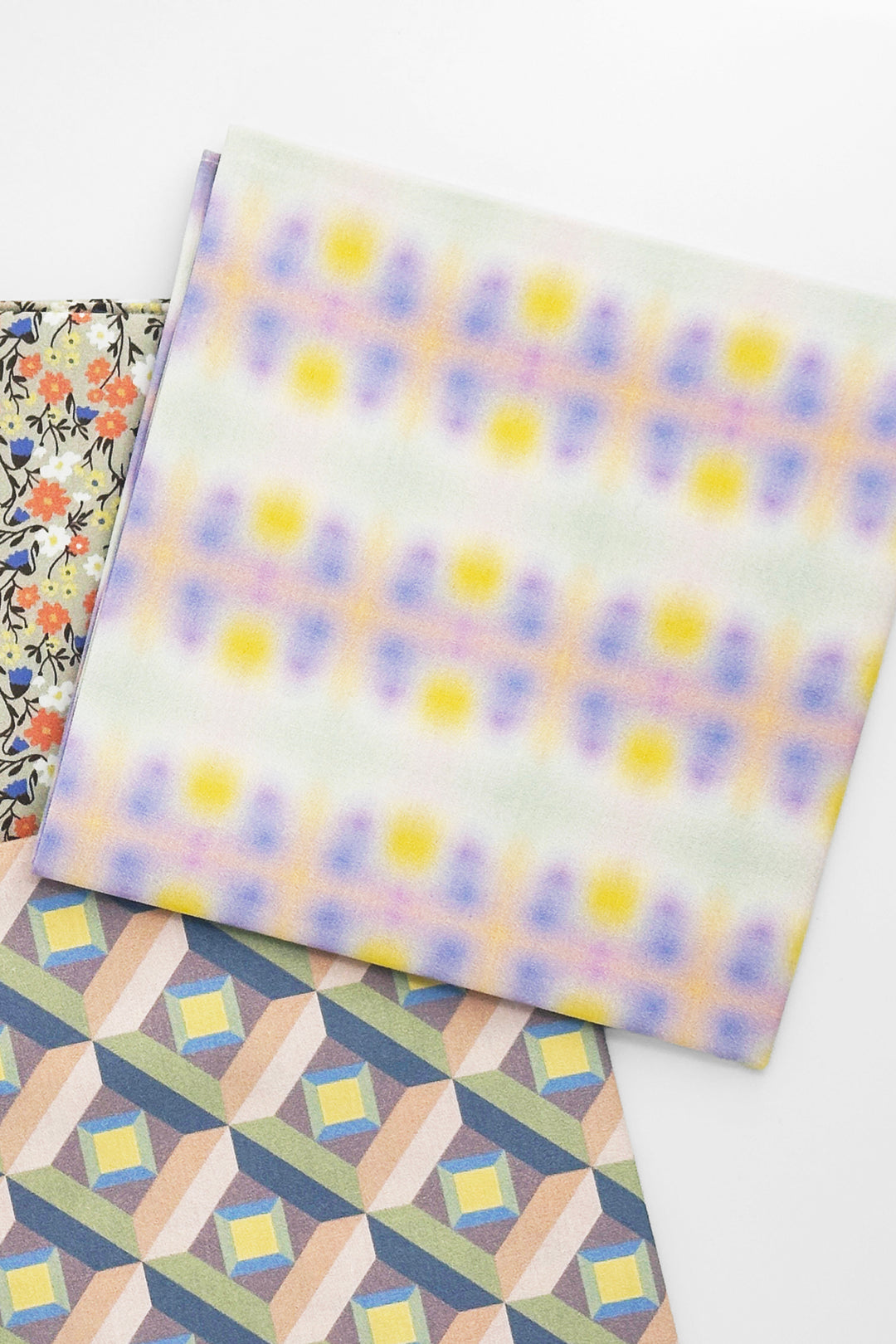 flat laid furoshiki cloth with gradient print layered with geometric pattern