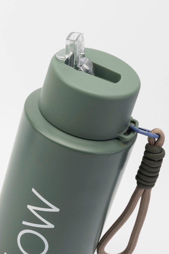 close up of flip mouthpiece on green insulated flow bottle