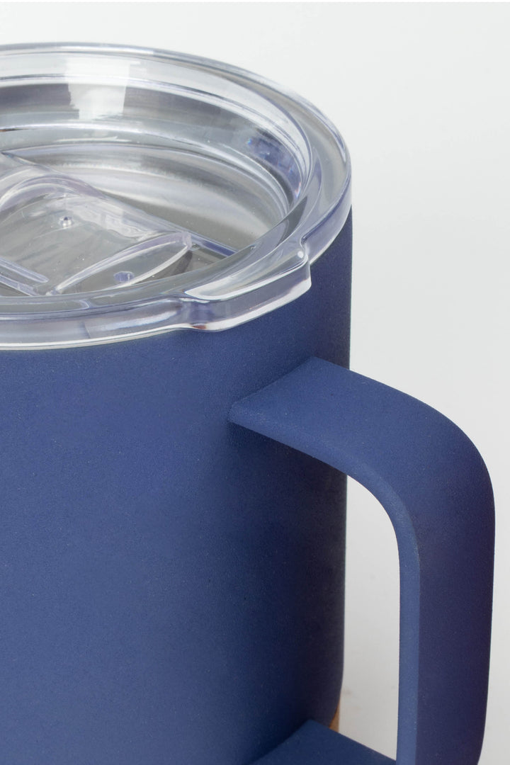 close up of clear AS lid and handle on blue insulated mug with cork base
