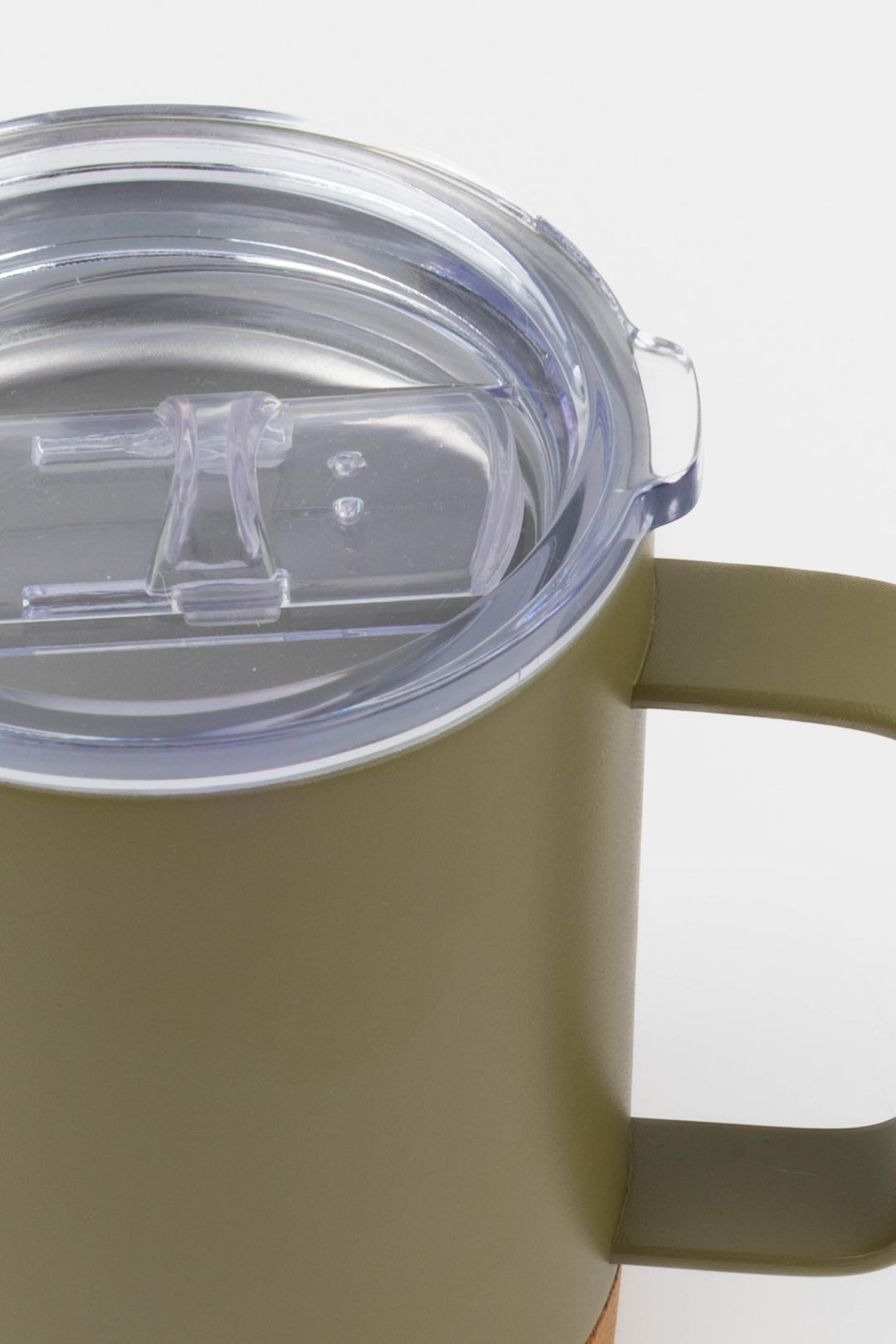 close up of clear lid and handle on green insulated mug with cork base

