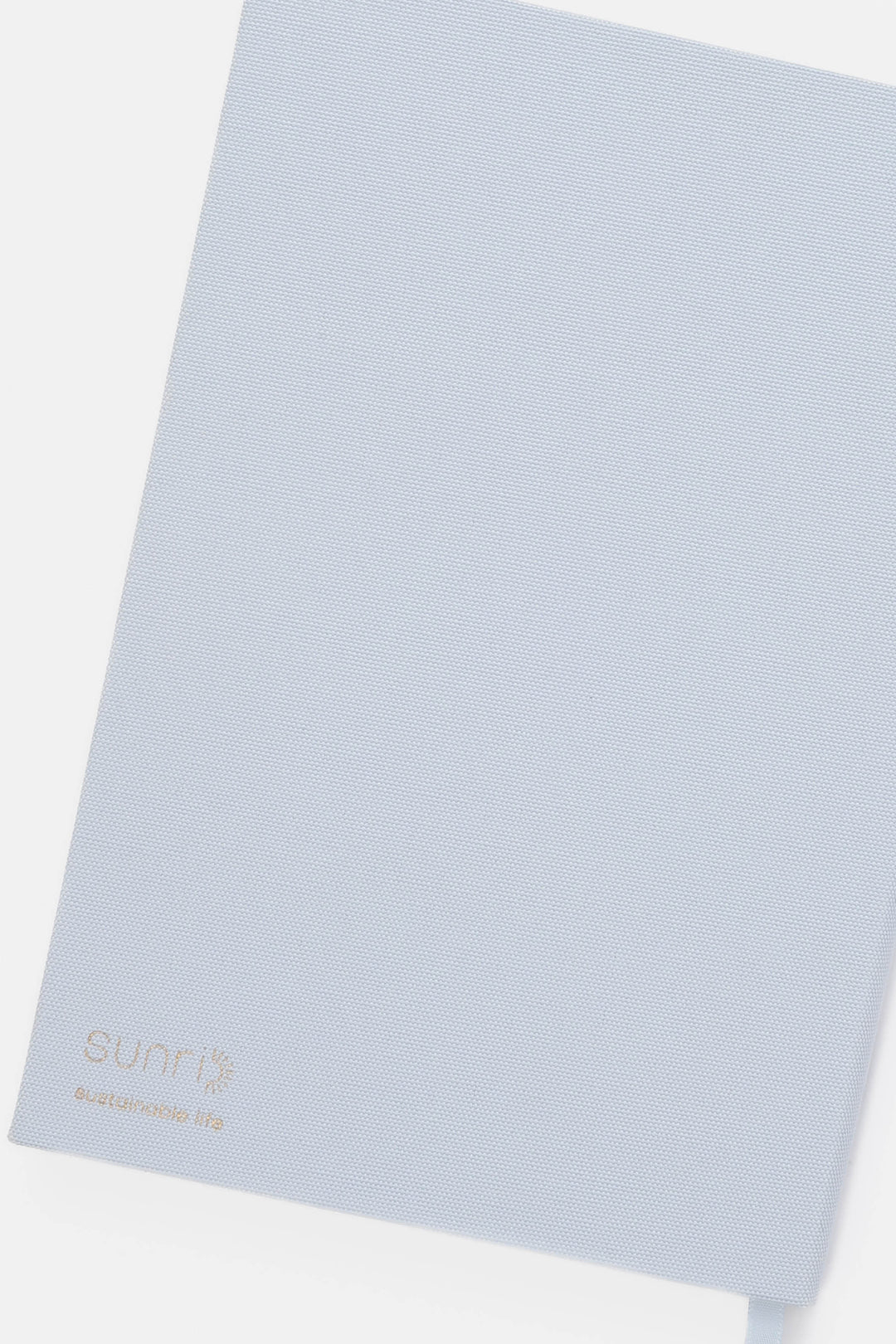 Light blue backside of notebook with 'SUNRI' branding 