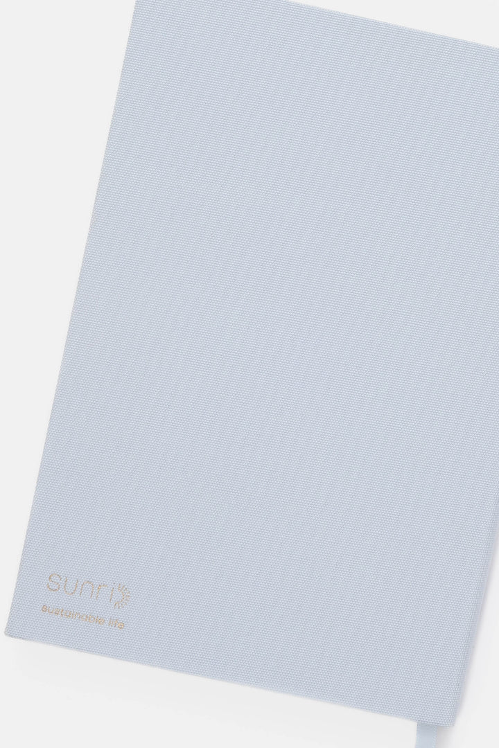 Light blue backside of notebook with 'SUNRI' branding 