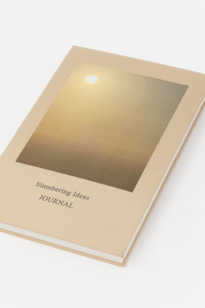 Journal titled 'Slumbering Ideas' with a gold cover 