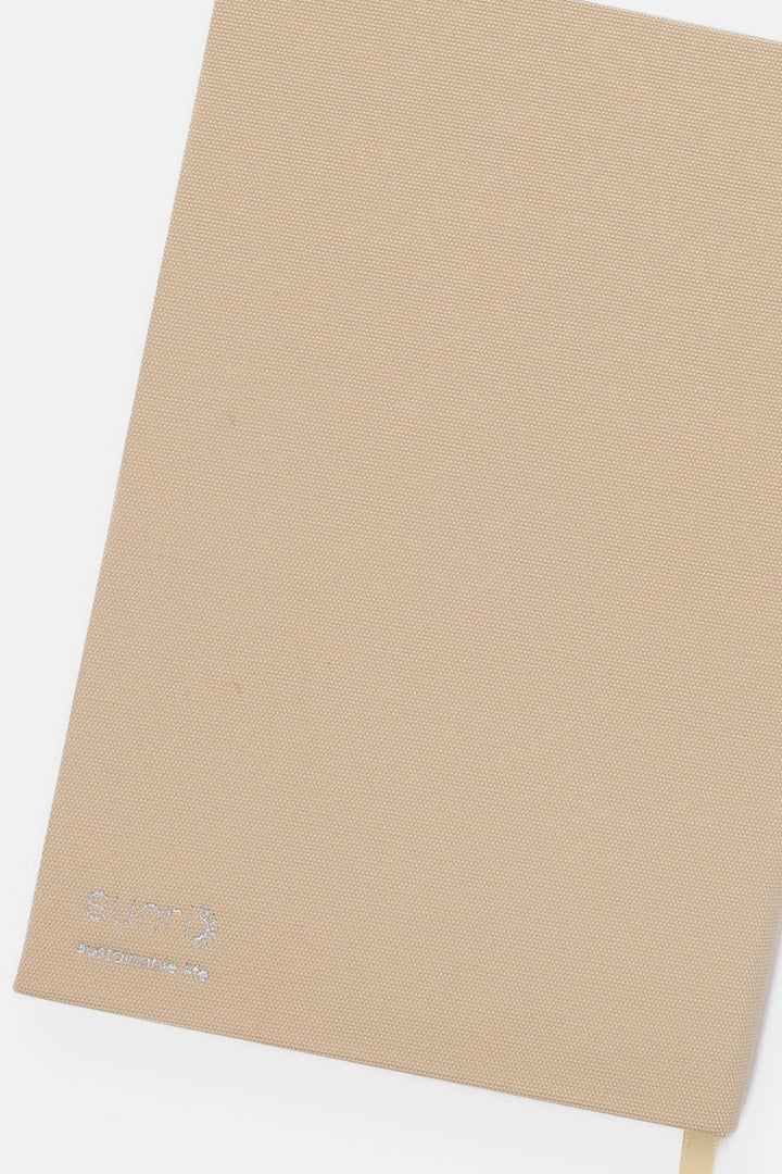 Beige backside of journal with SUNRI brand logo 