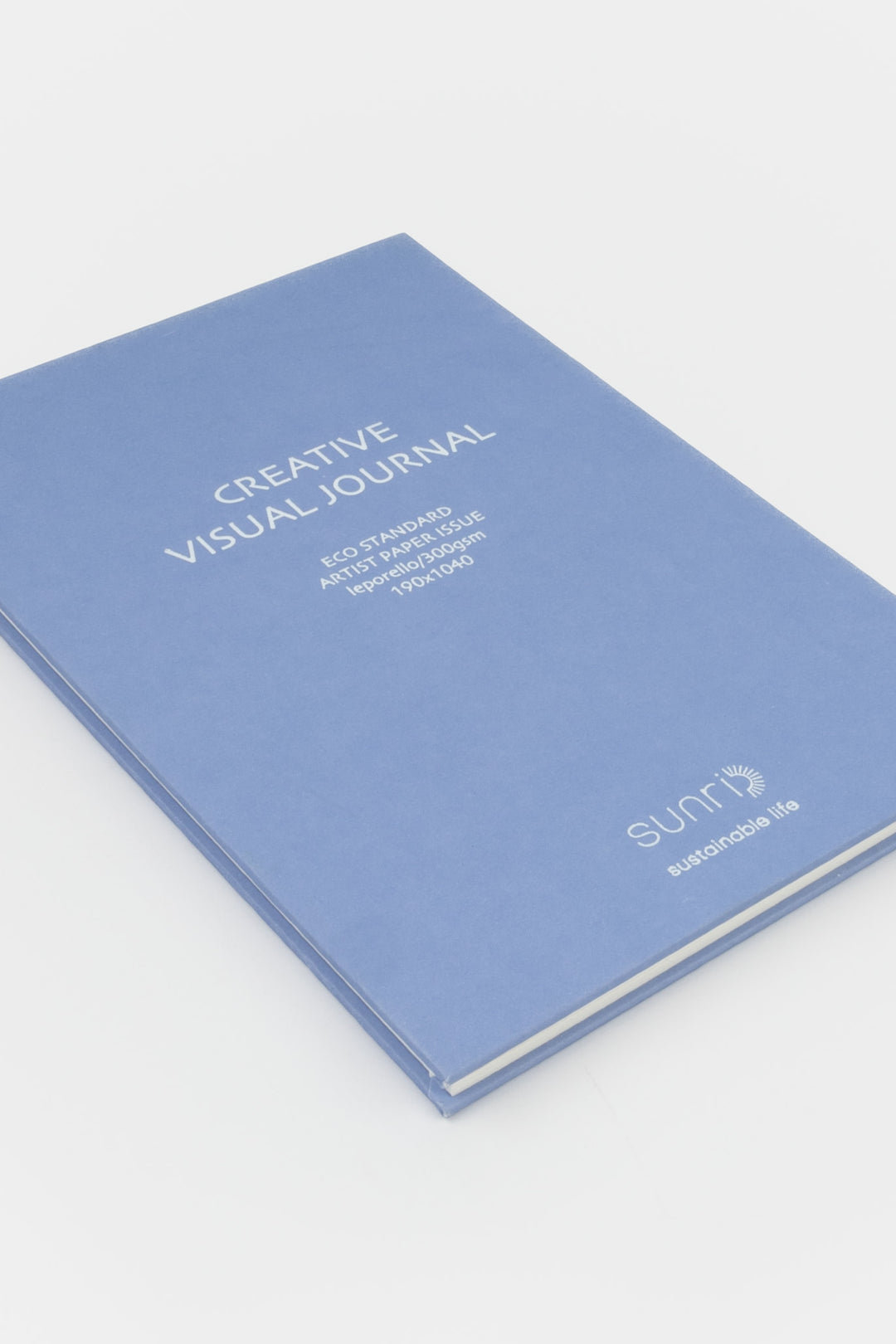 purple 鈥楥reative Visual Journal鈥?with 鈥榮unri鈥?branding shown closed at an angle highlighting slim hardcover profile
