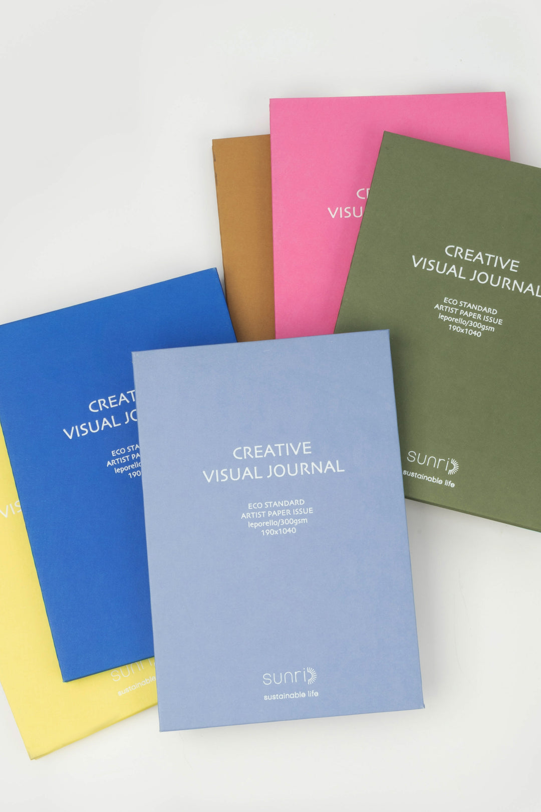 Assorted colour range 鈥楥reative Visual Journal鈥?with 鈥榮unri鈥?branding arranged fan-style