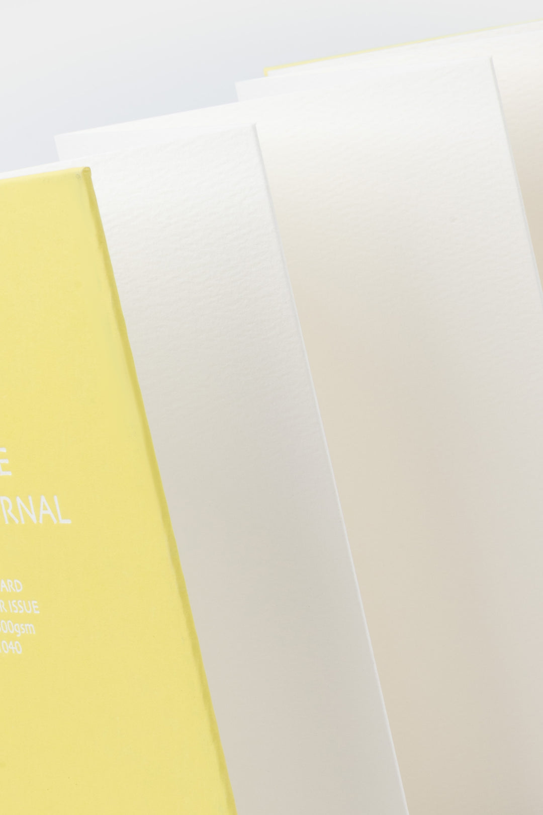 Close view of leporello folded sketch pages inside the yellow 鈥楥reative Visual Journal鈥?with 鈥榮unri鈥?branding
