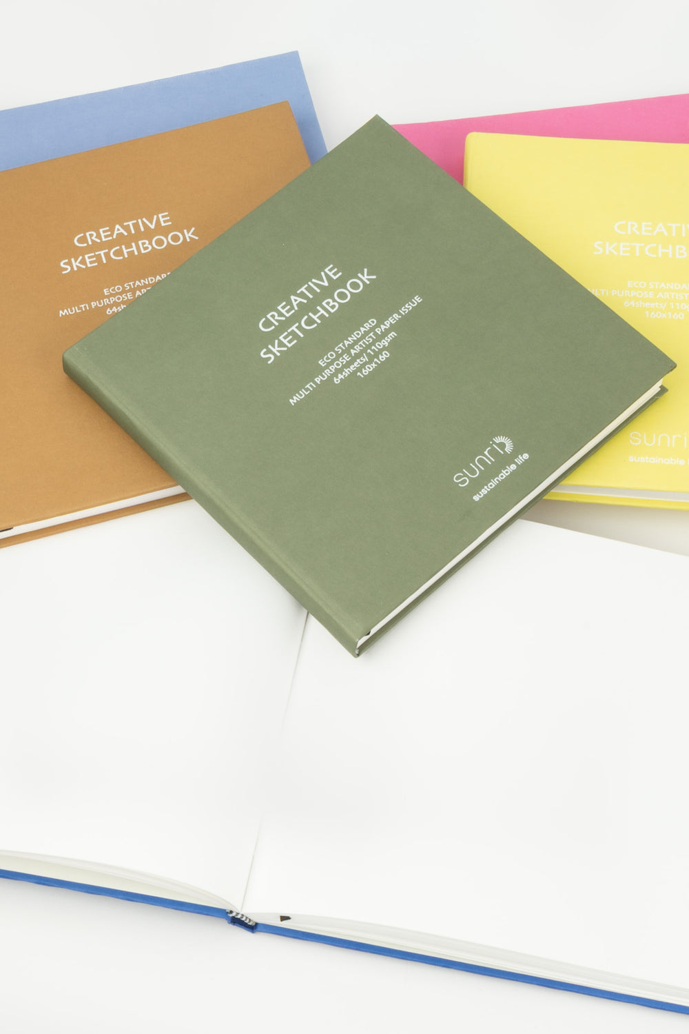 Assorted creative square sketchbooks showing colours options with open pages below
