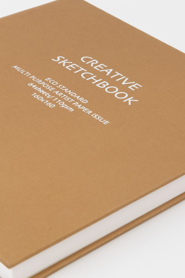 Brown sketchbook with white text on a white background