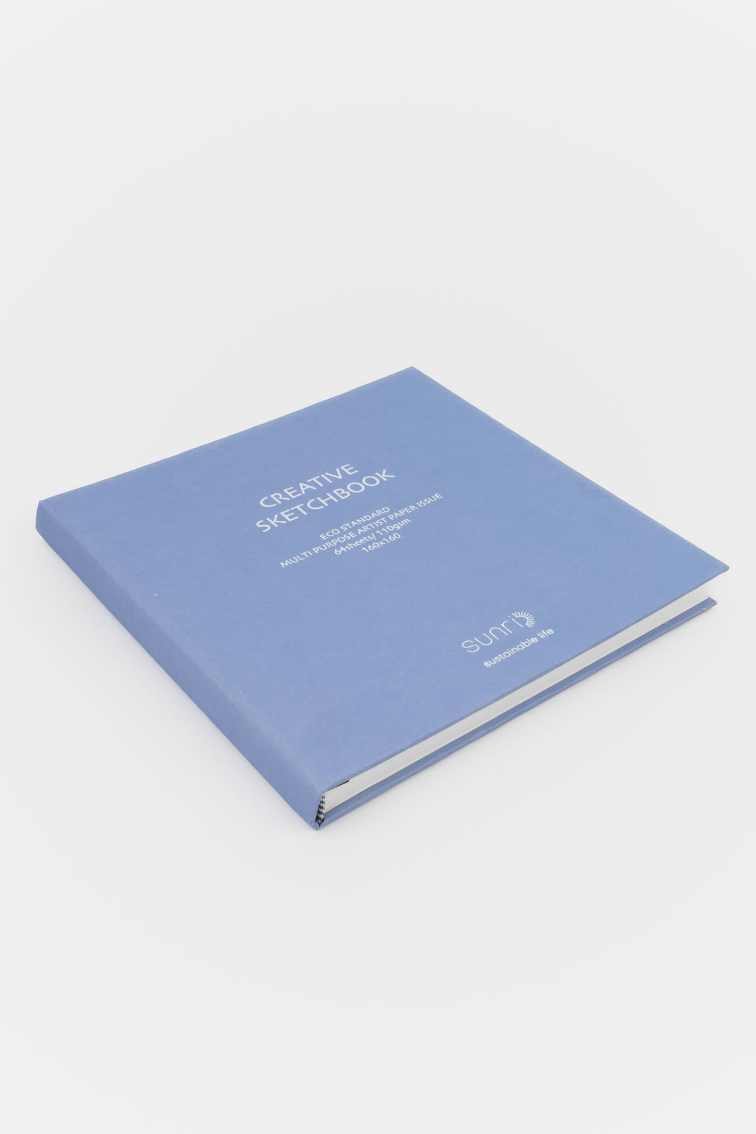 Creative square purple sketchbook with sunri branding lying closed on white background
