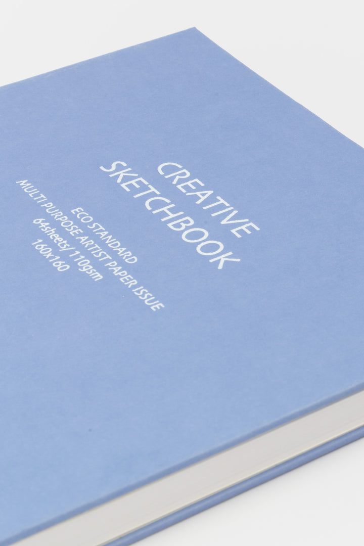 Close up of purple creative square sketchbook cover showing printed specifications and smooth hardcover texture
