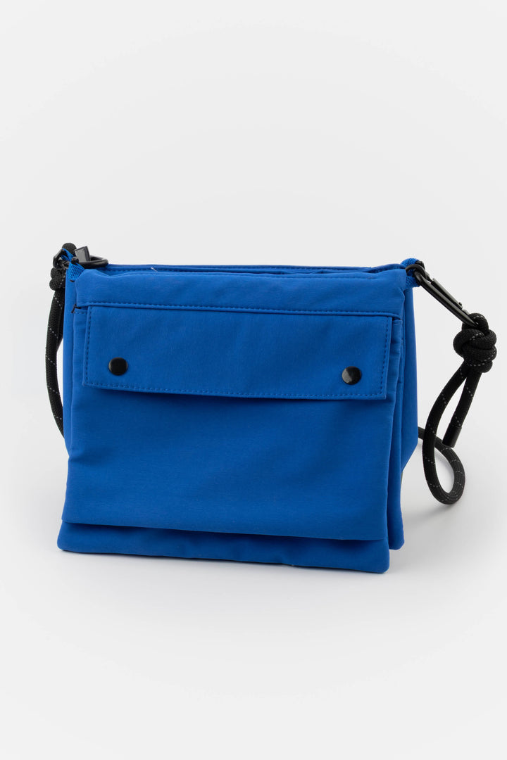 Blue utility bag with black straps on a white background