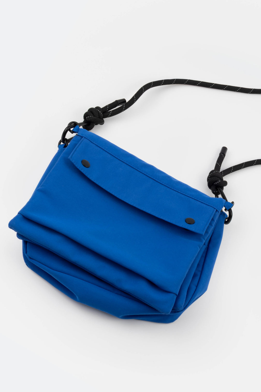Blue bag with a black strap on a white background