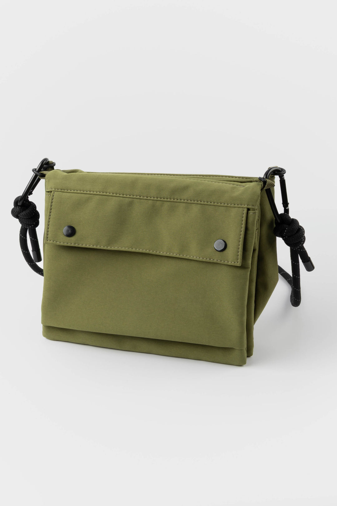 Green bag with black straps on a white background