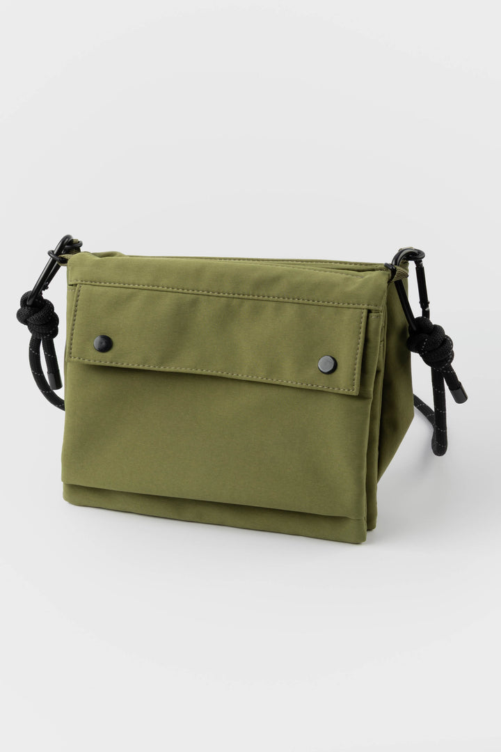 Green bag with black straps on a white background